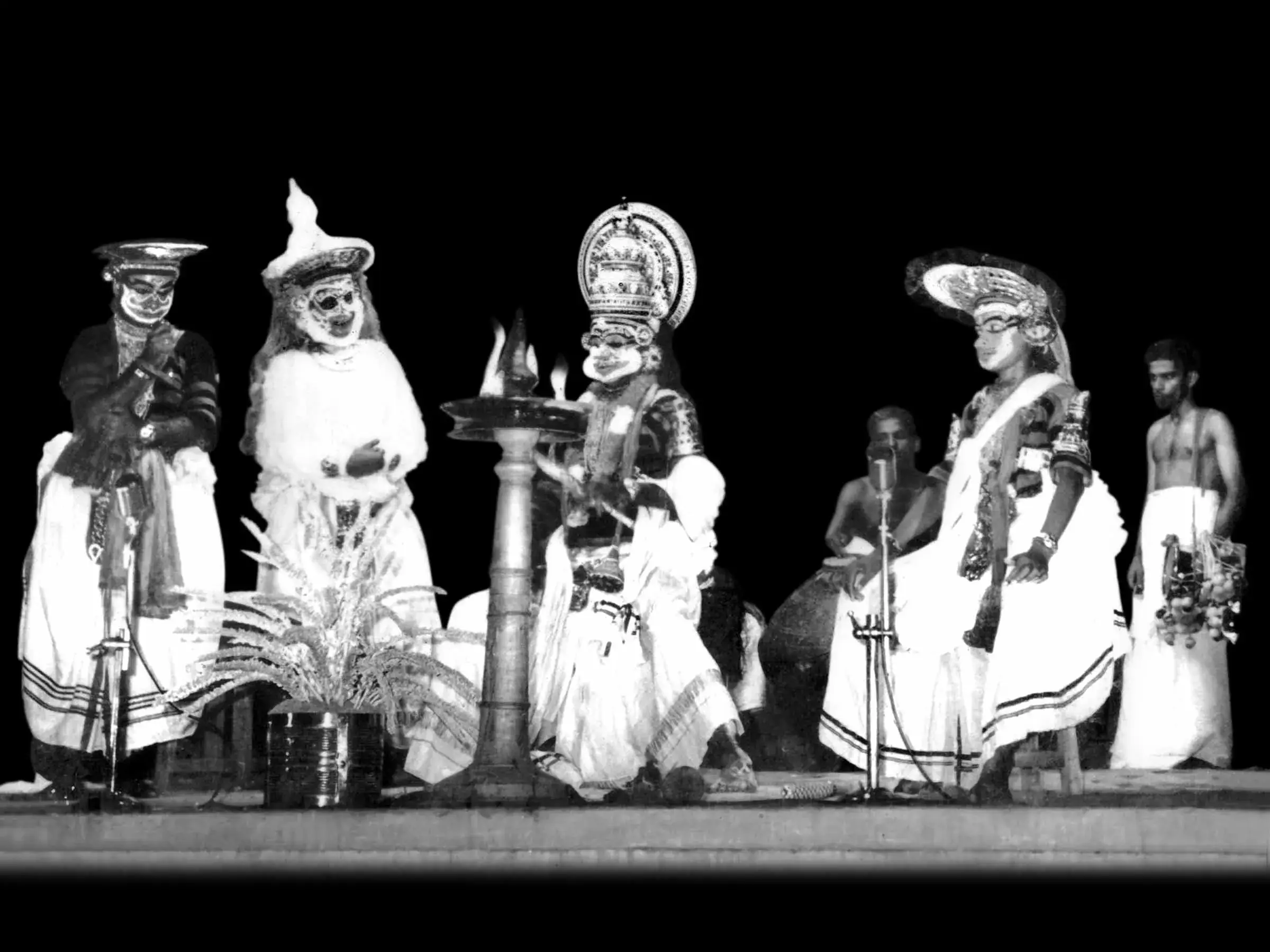 Koodiyattam performers on stage in elaborate costume